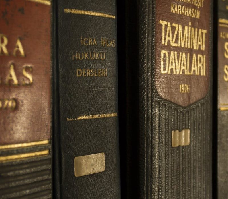 Detailed close-up of law and regulation books on a bookshelf, emphasizing education and knowledge.